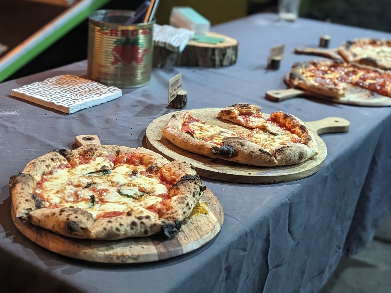 Three Fed by Fed and Ben pizzas served on wooden boards at a private event