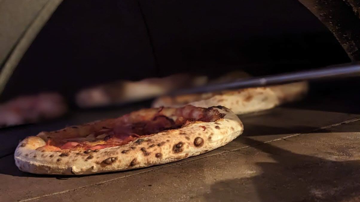 Pizza coming out of the oven